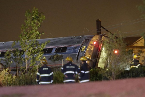 Emergency personnel work the scene of a train wreck, Tuesday, May 12, 2015, in Philadelphia. An Amtrak train headed to New York City derailed and crashed in Philadelphia. (AP Photo/Matt Slocum)