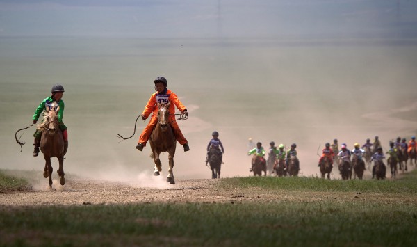 Mongolian child jockeys compete in a horse racing competition during the second day of the Naadam Festival held in Khui Doloon Khudag, on the outskirts of Ulan Bator, Mongolia, Thursday, July 12, 2012. Mongolians celebrate the anniversary of Genghis Khan's march to the world conquest with the annual sporting festival featuring traditional Mongolian events such as wrestling, archery, and horse racing. (AP Photo/Andy Wong)