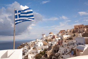 Greek flag waving in the village of Oia