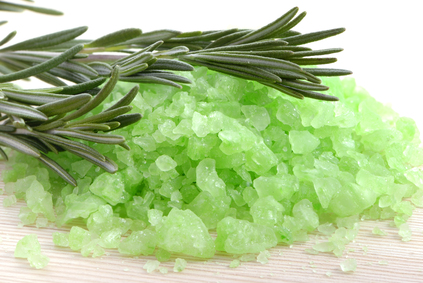 Bath salt and rosemary branch on the wood background