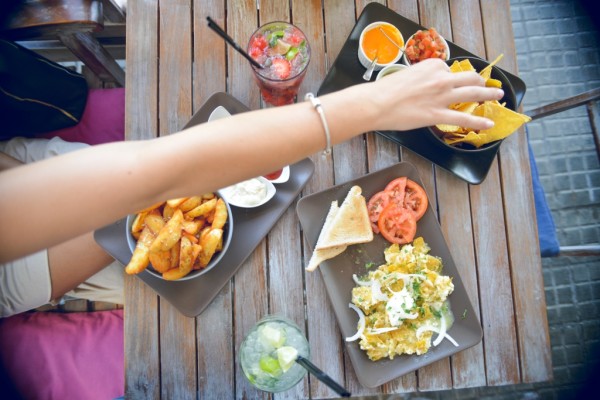 8-Girls-Hand-Reaching-accross-Mexican-Tapas-Cafe-Table-Ed-Gregory-Stokpic-SMALLER-1024x683