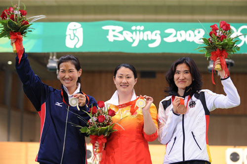 (0808013) -- BEIJING, Aug. 13, 2008 (Xinhua) -- Gold medalist Chen Ying of China (C), silver medalist Gundegmaa Otryad of Mongolia (L) and bronze medalist Munkhbayar Dorjsuren of Germany stand on the podium during the awarding ceremony of the women's 25m pistol final of the Beijing 2008 Olympic Games shooting event at the Beijing Shooting Range Hall in Beijing, China, Aug. 13, 2008. Chen Ying shot 793.4 points to win the gold medal of the event and set a new Olympic record. (Xinhua/Jiao Weiping) (dzl)