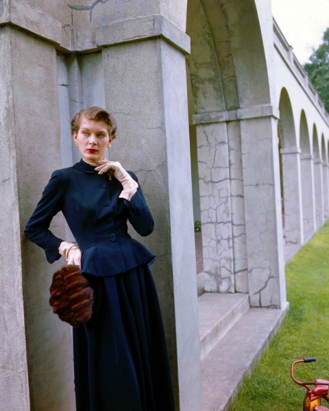 1948 --- Betty Bridges models a wool bengaline dress, a mink muff designed by Ester Dorothy, and gloves designed by Aris. --- Image by © Genevieve Naylor/Corbis